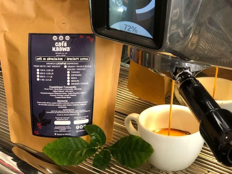 Espresso machine pouring coffee into 2 small coffee cups, besides a bag of Specialty Coffee Chiapas Jaltenango